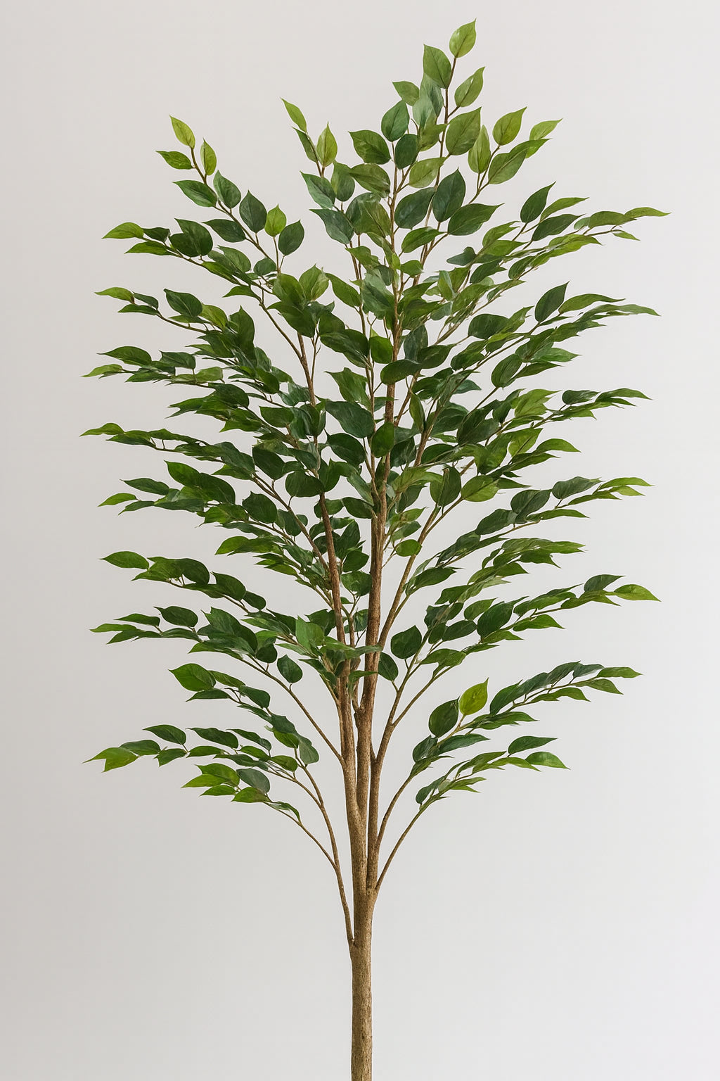 Artificial tree with green leaves on a plain background